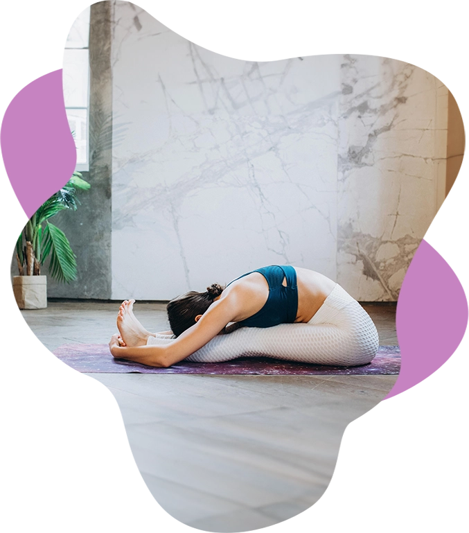 Woman stretching on yoga mat.